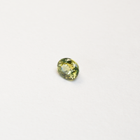 1 carat pear parti teal sapphire with mixed green and yellow color.