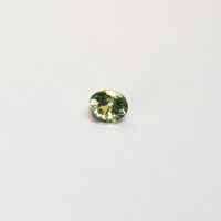 1 carat pear parti teal sapphire with mixed green and yellow color.