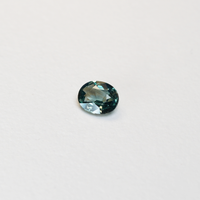1.10 carat oval parti teal sapphire with mixed green and blue color.