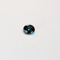 1.1 carat oval parti teal sapphire with mixed green and blue color.