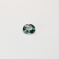 1.10 carat oval parti teal sapphire with mixed green and blue color.