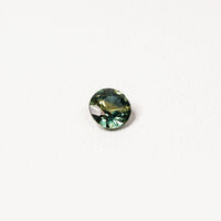 Australian parti sapphire 1.25ct — teal and yellow-green zoning visible at angle — Ruhuna Gemstones