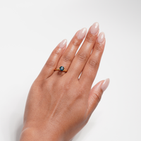 1.3 carat round parti teal sapphire ring with mixed green and blue color.