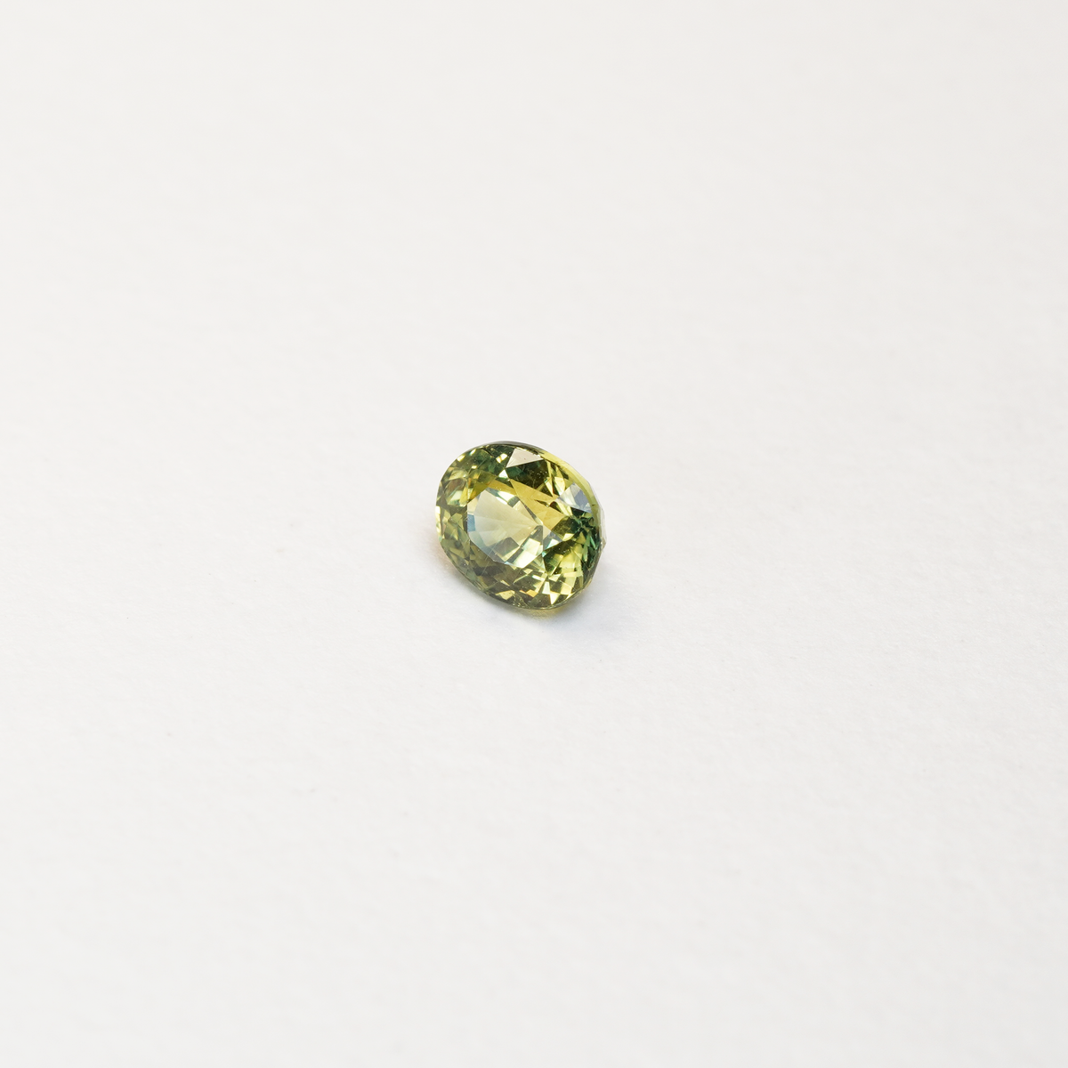 1 carat pear parti teal sapphire with mixed green and yellow color.