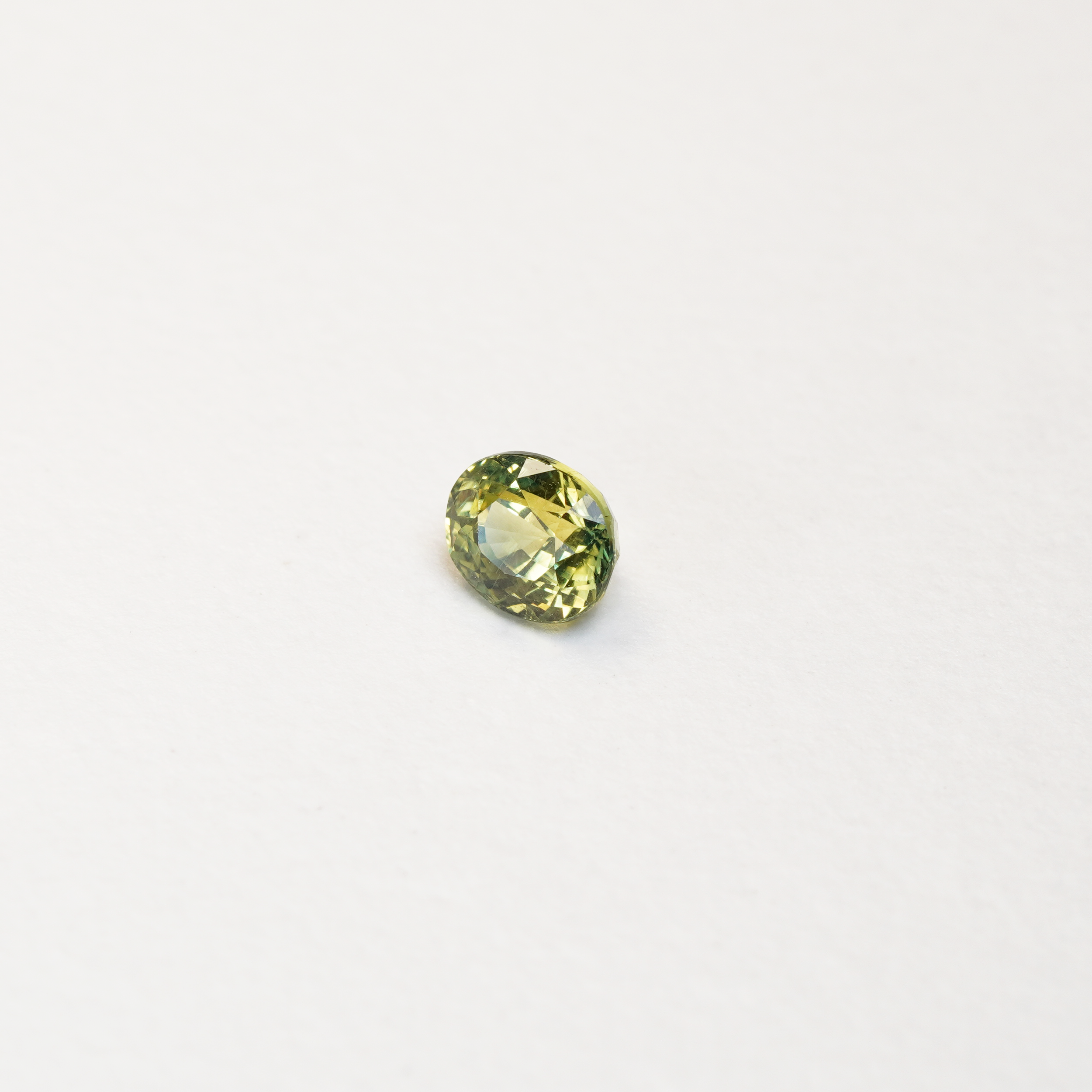 1 carat pear parti teal sapphire with mixed green and yellow color.
