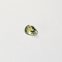1 carat pear parti teal sapphire with mixed green and yellow color.