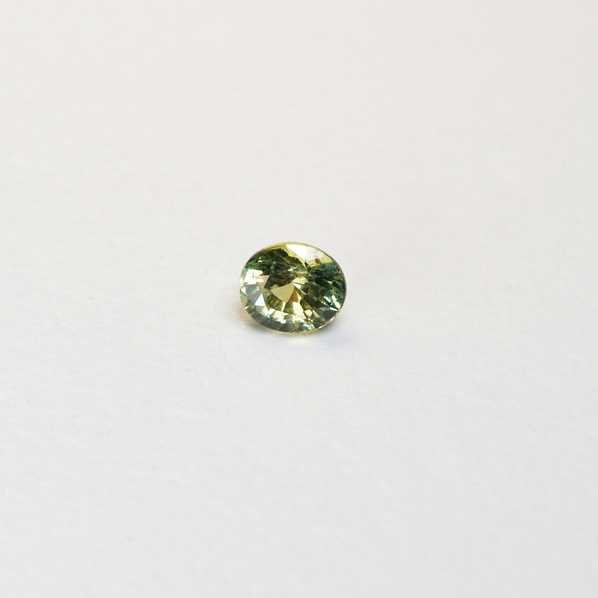 1 carat pear parti teal sapphire with mixed green and yellow color.