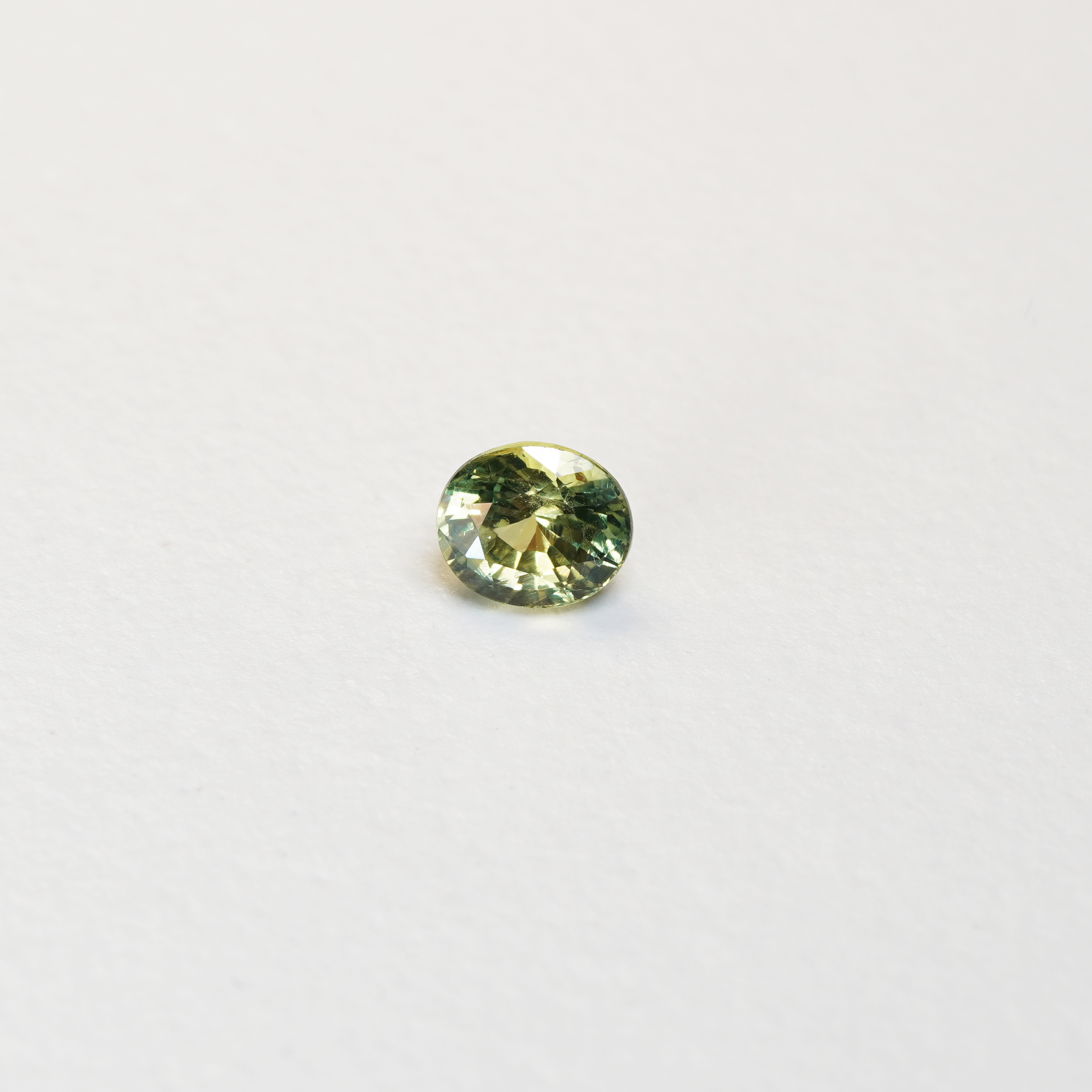 1 carat pear parti teal sapphire with mixed green and yellow color.