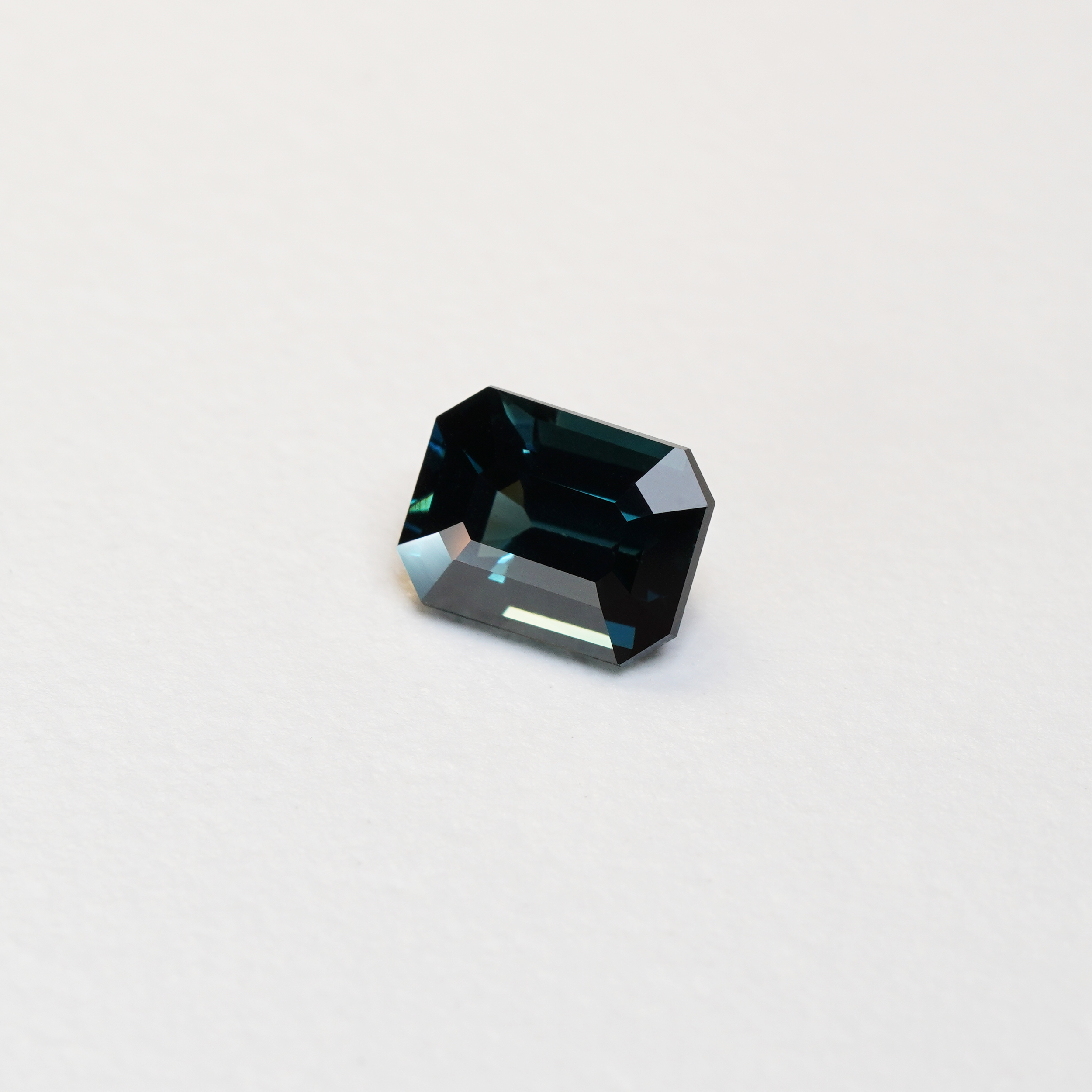 3.06 carat emerald cut teal parti sapphire with blue and green