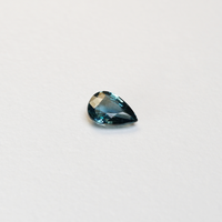 1 carat pear parti teal sapphire with mixed green and blue color.