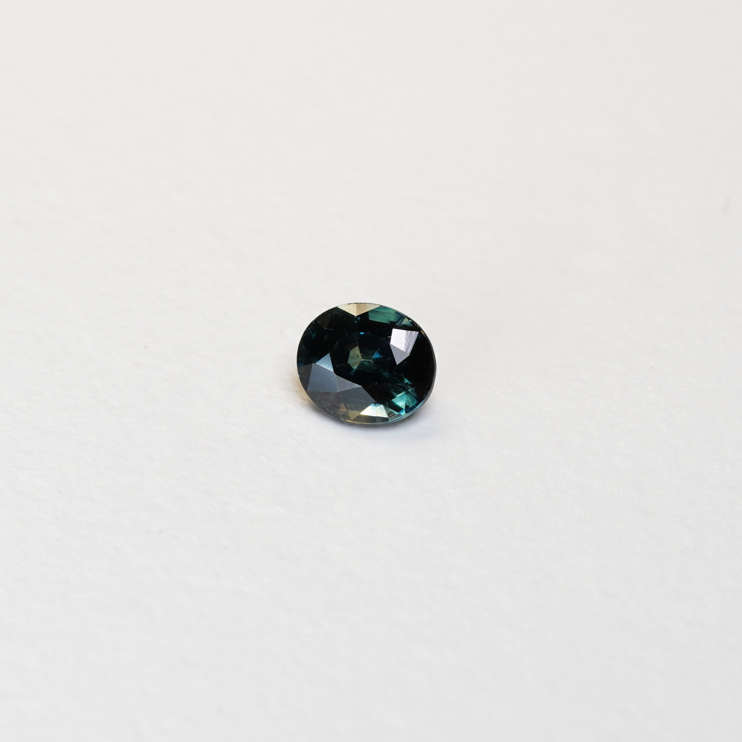 1.1 carat oval parti teal sapphire with mixed green and blue color.
