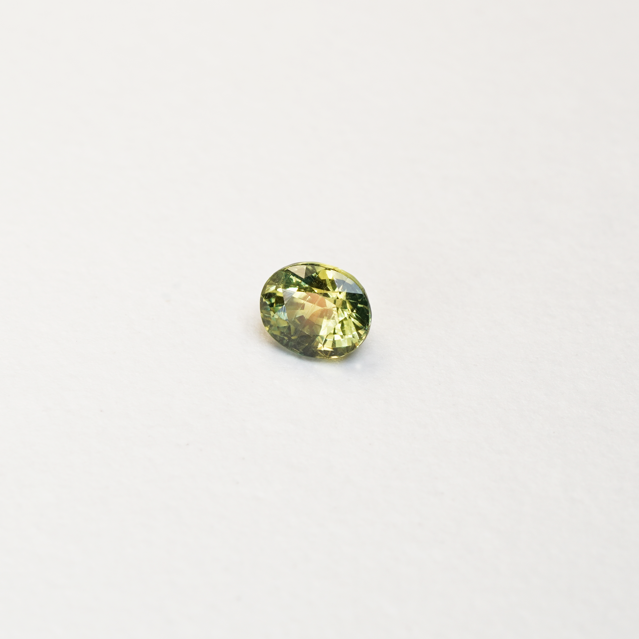 1 carat pear parti teal sapphire with mixed green and yellow color.
