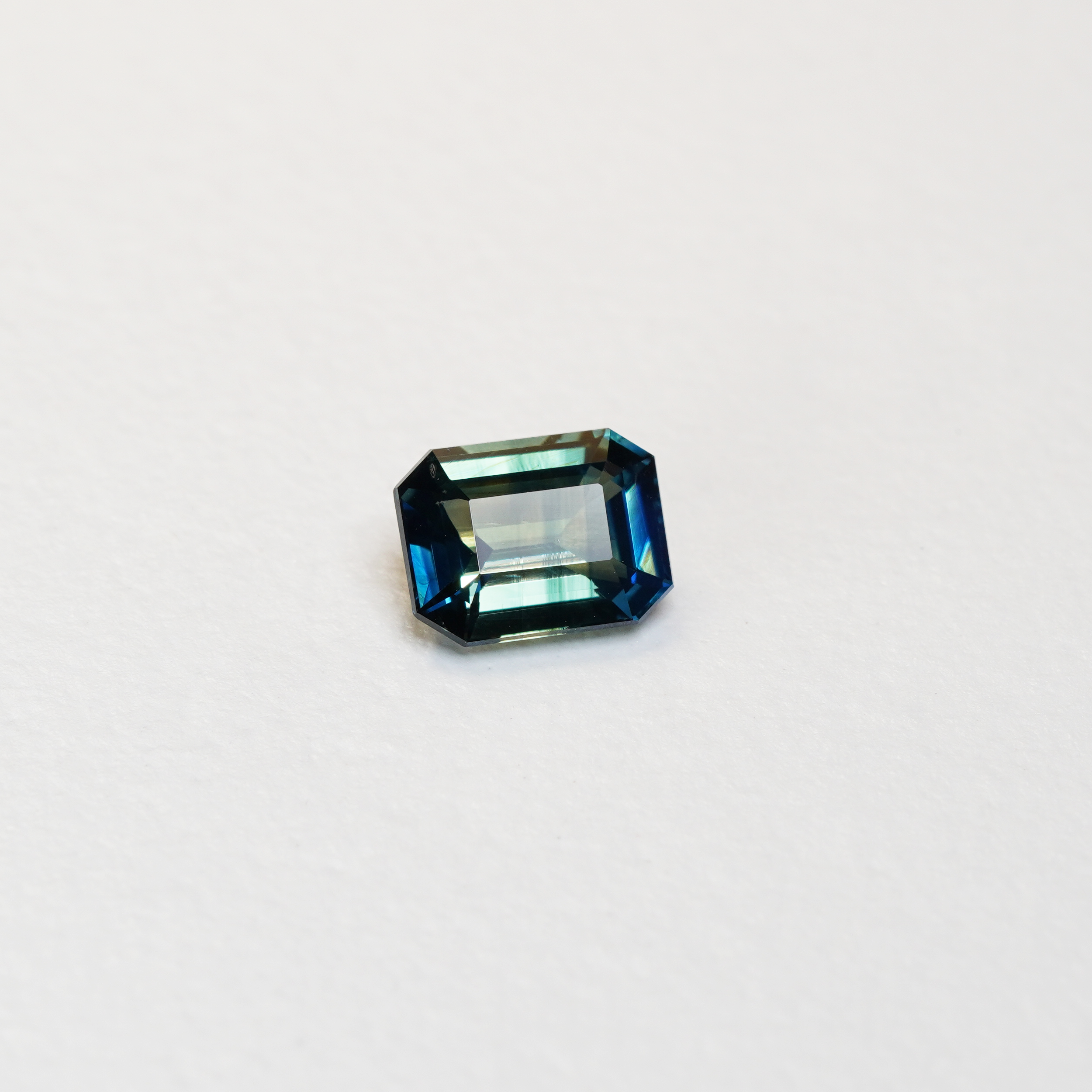 2.02 carat emerald cut teal parti sapphire with blue and green