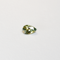 1 carat pear parti teal sapphire with mixed green and yellow color.