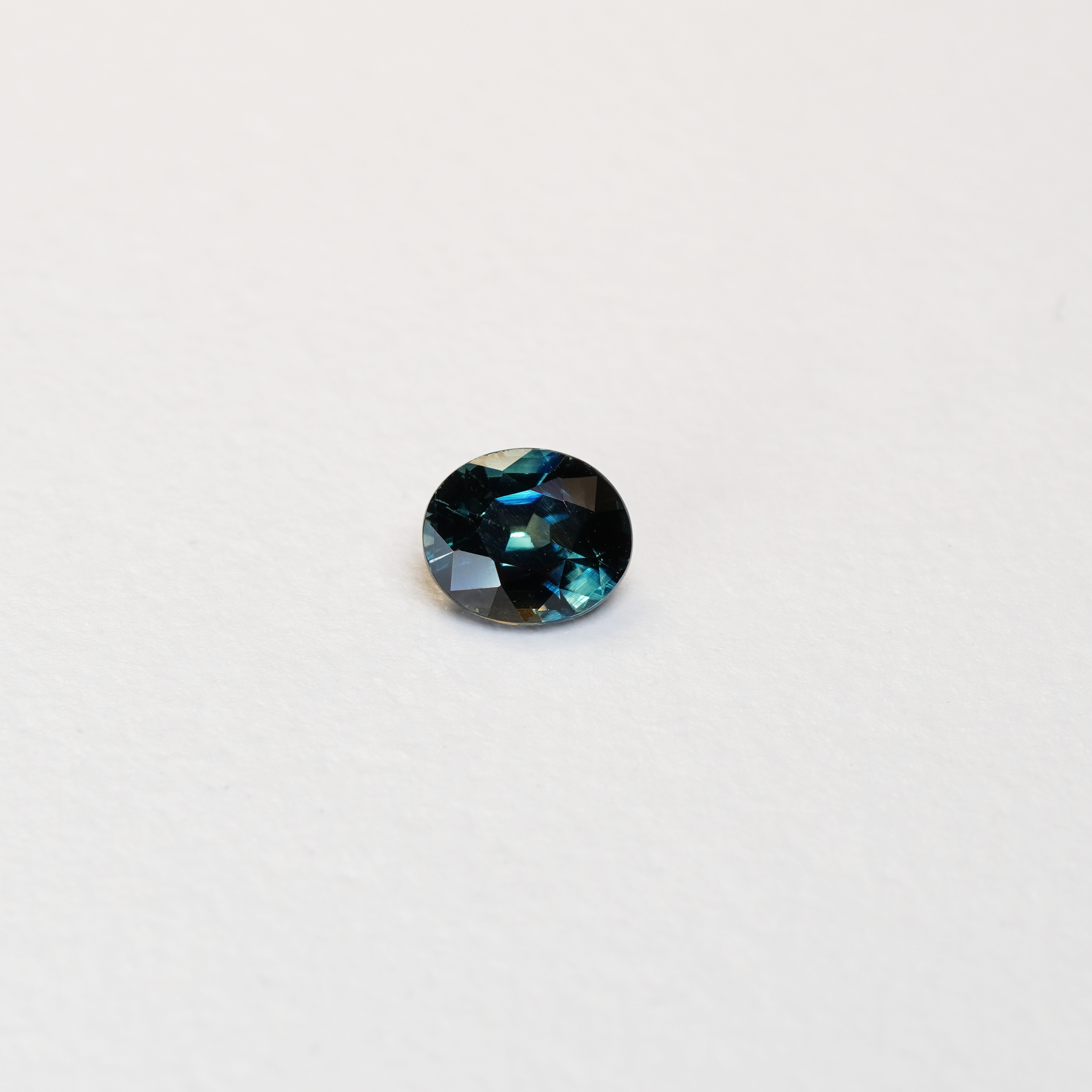 1.1 carat oval parti teal sapphire with mixed green and blue color.