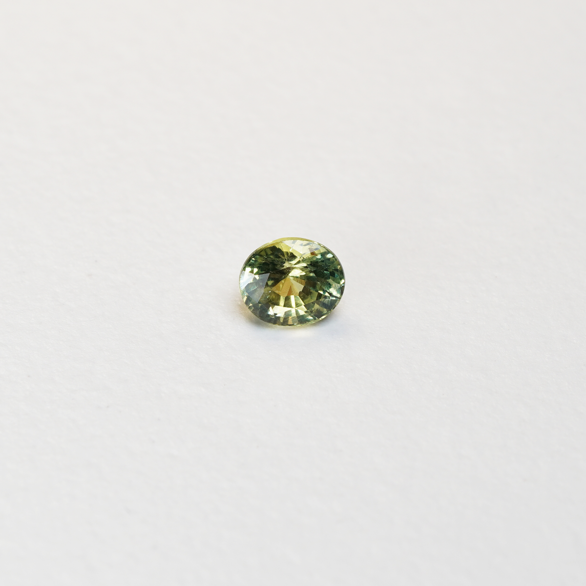 1 carat pear parti teal sapphire with mixed green and yellow color.
