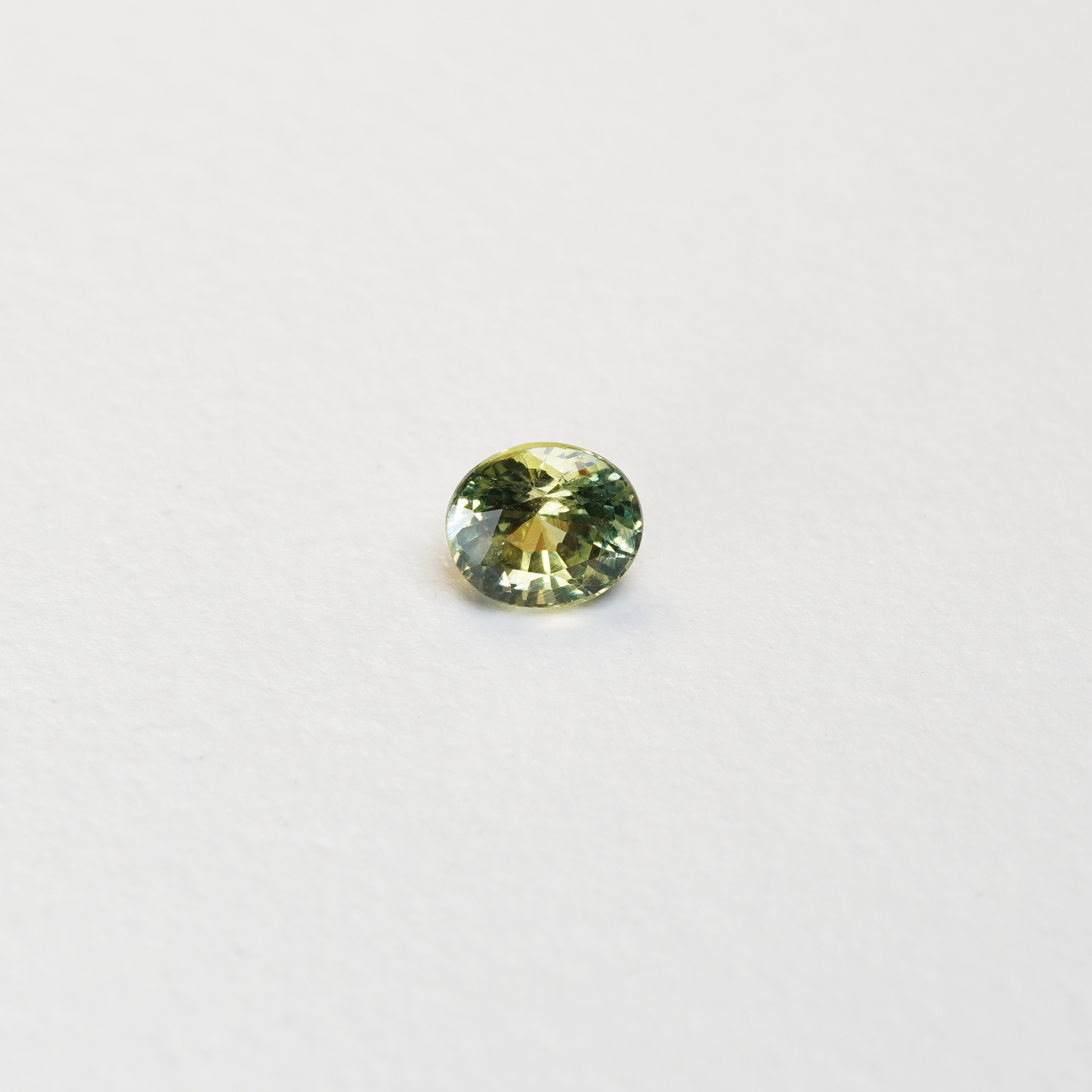 1 carat pear parti teal sapphire with mixed green and yellow color.