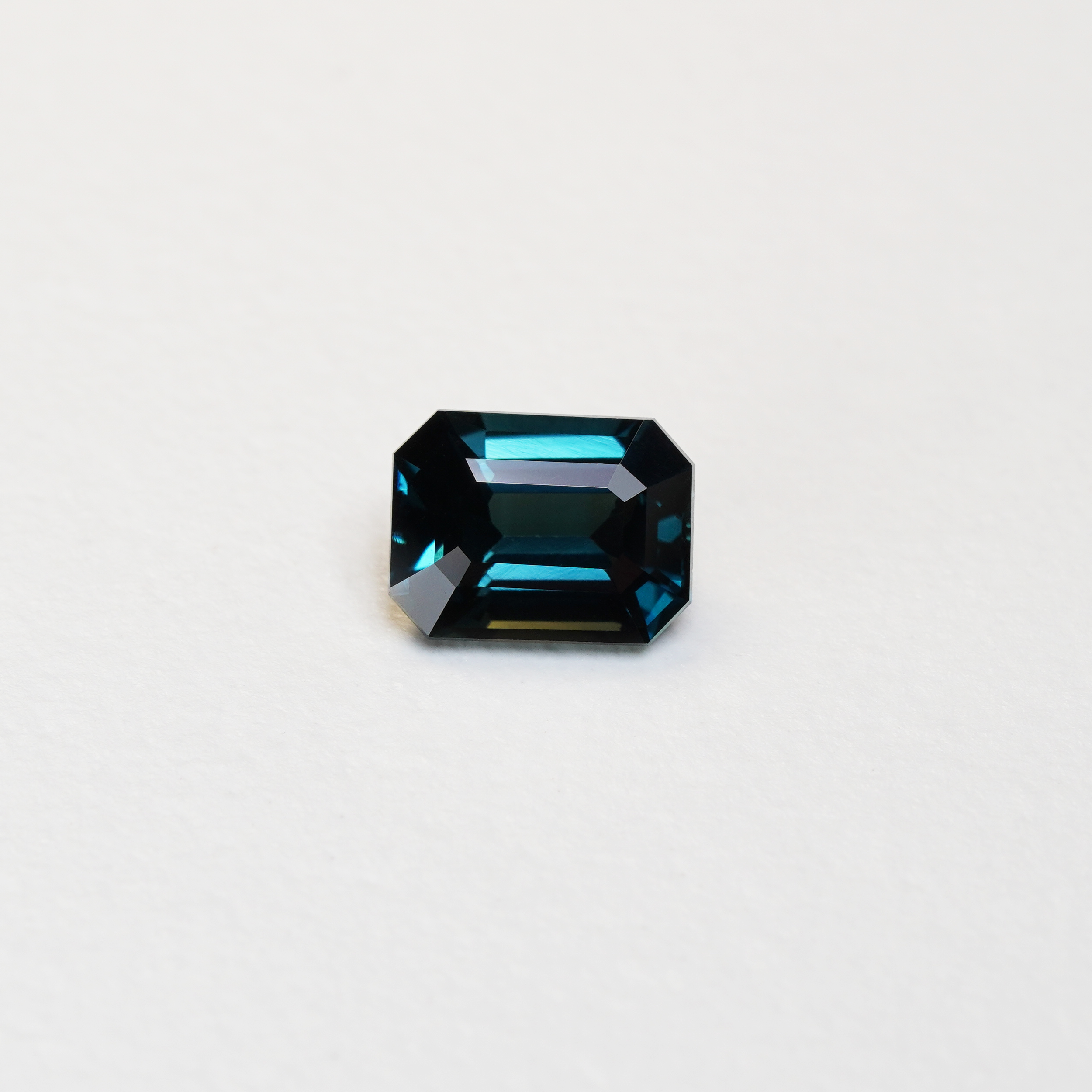 3.06 carat emerald cut teal parti sapphire with blue and green