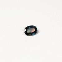  1.25ct Australian parti sapphire oval — deep teal with copper flash through table, face-up — Ruhuna Gemstones
