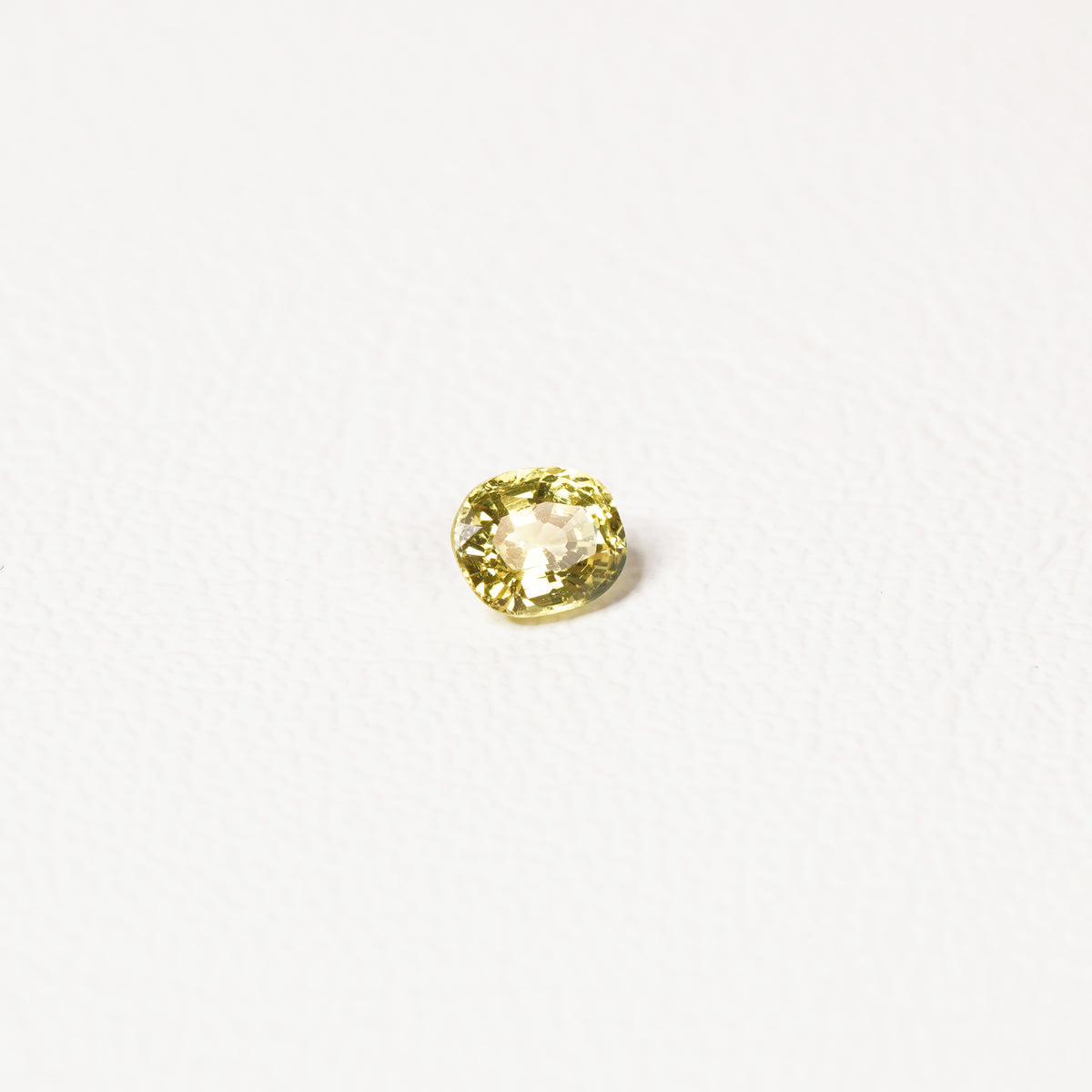 0.85ct Australian yellow-green sapphire cushion — soft pale chartreuse colour, face-up view — Ruhuna Gemstones