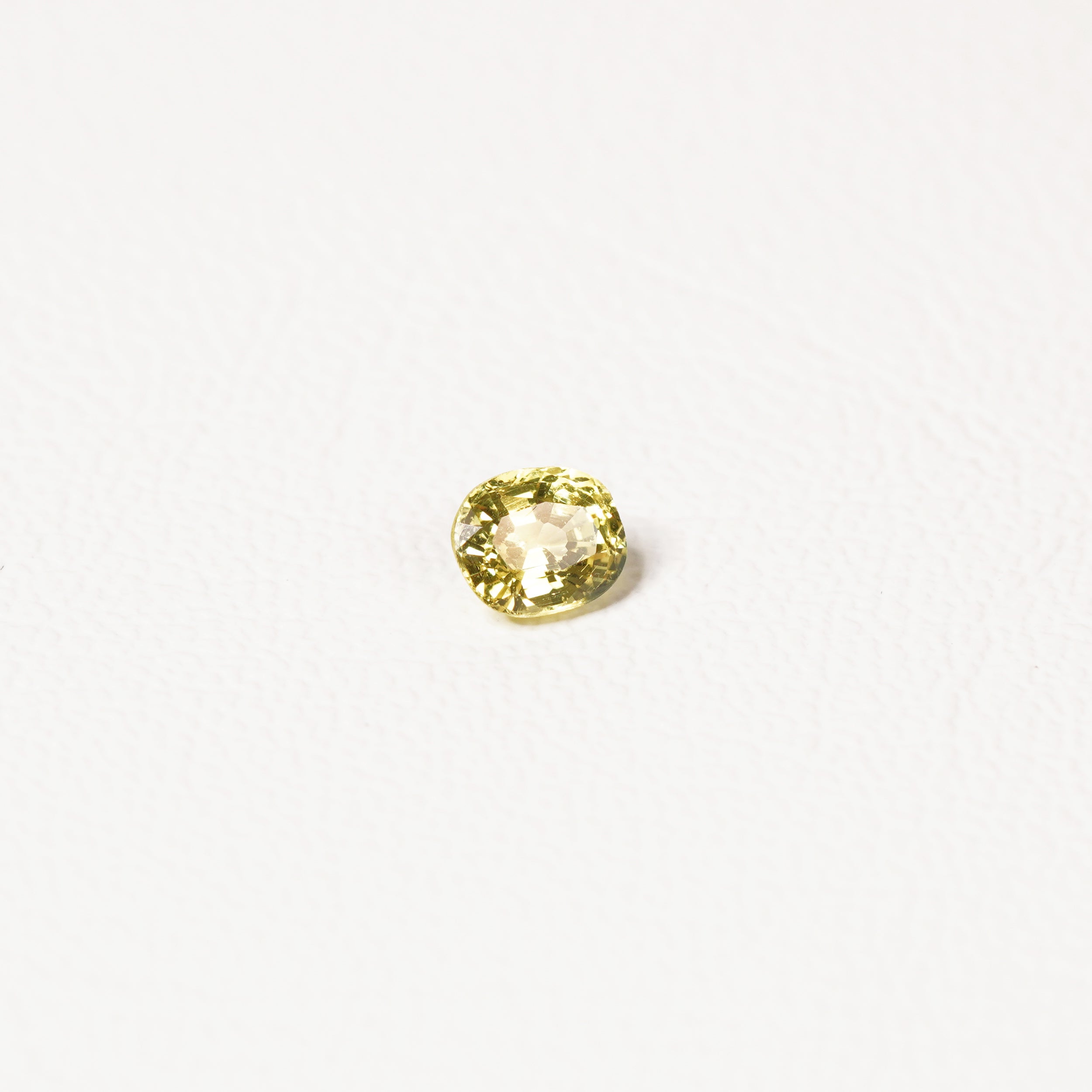0.85ct Australian yellow-green sapphire cushion — soft pale chartreuse colour, face-up view — Ruhuna Gemstones