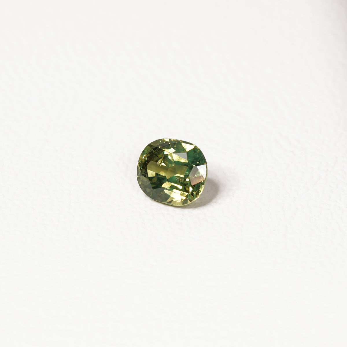1.70ct Australian parti sapphire cushion — yellow-green centre with forest green crown, face-up — Ruhuna Gemstones