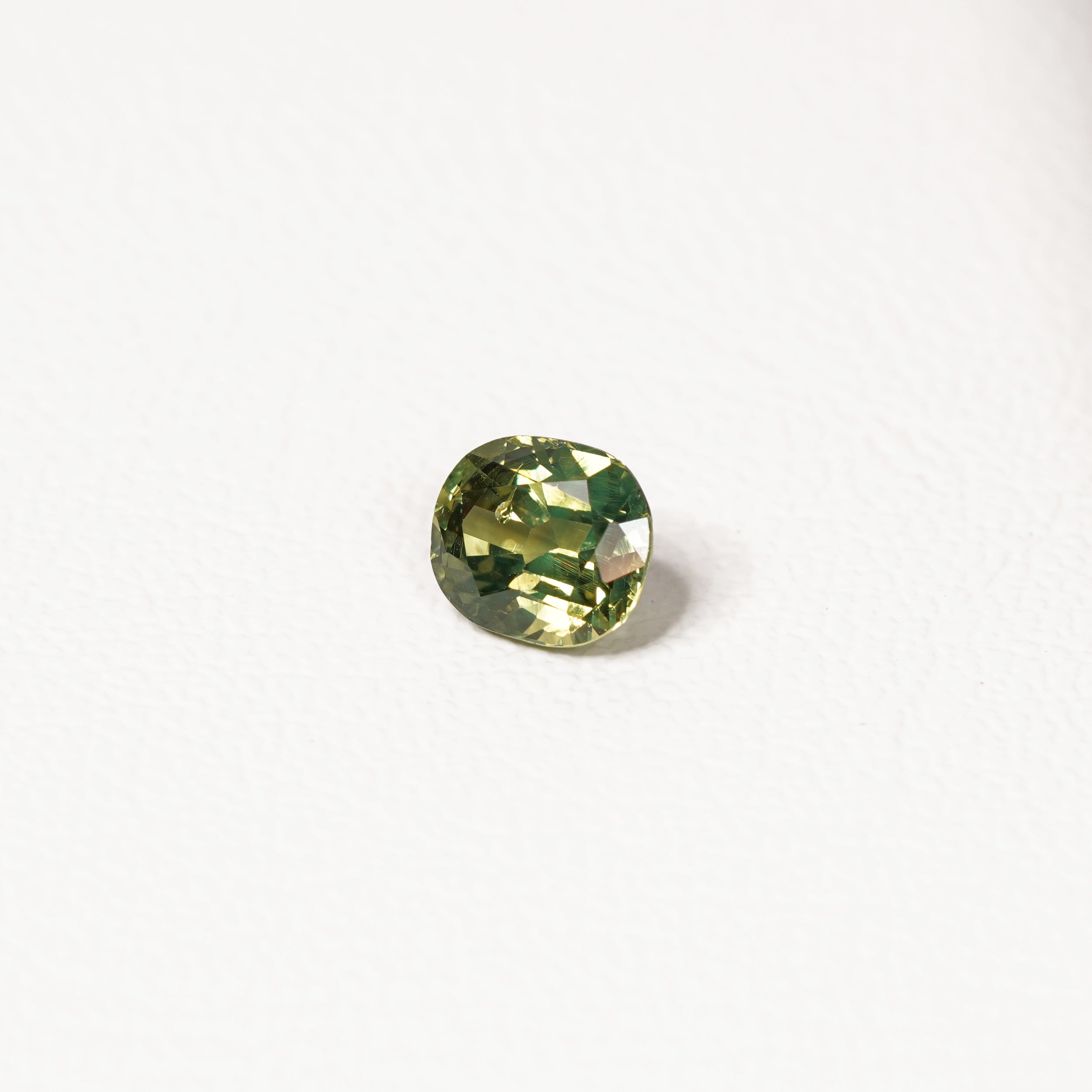 1.70ct Australian parti sapphire cushion — yellow-green centre with forest green crown, face-up — Ruhuna Gemstones