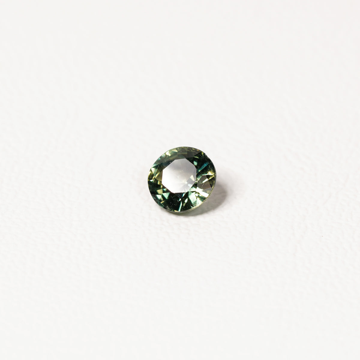 Australian parti sapphire 1.25ct — teal and yellow-green zoning visible at angle — Ruhuna Gemstones