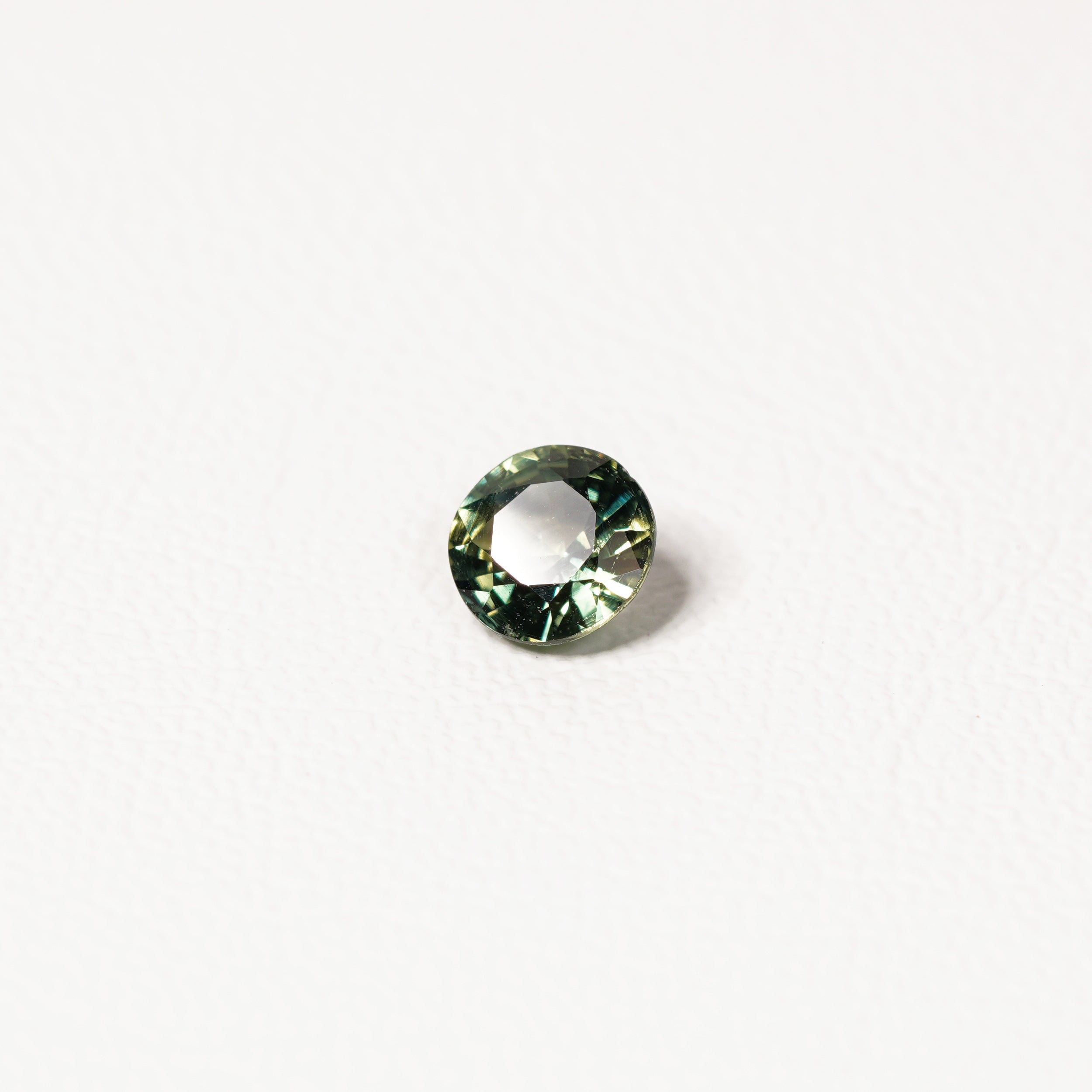 Australian parti sapphire 1.25ct — teal and yellow-green zoning visible at angle — Ruhuna Gemstones