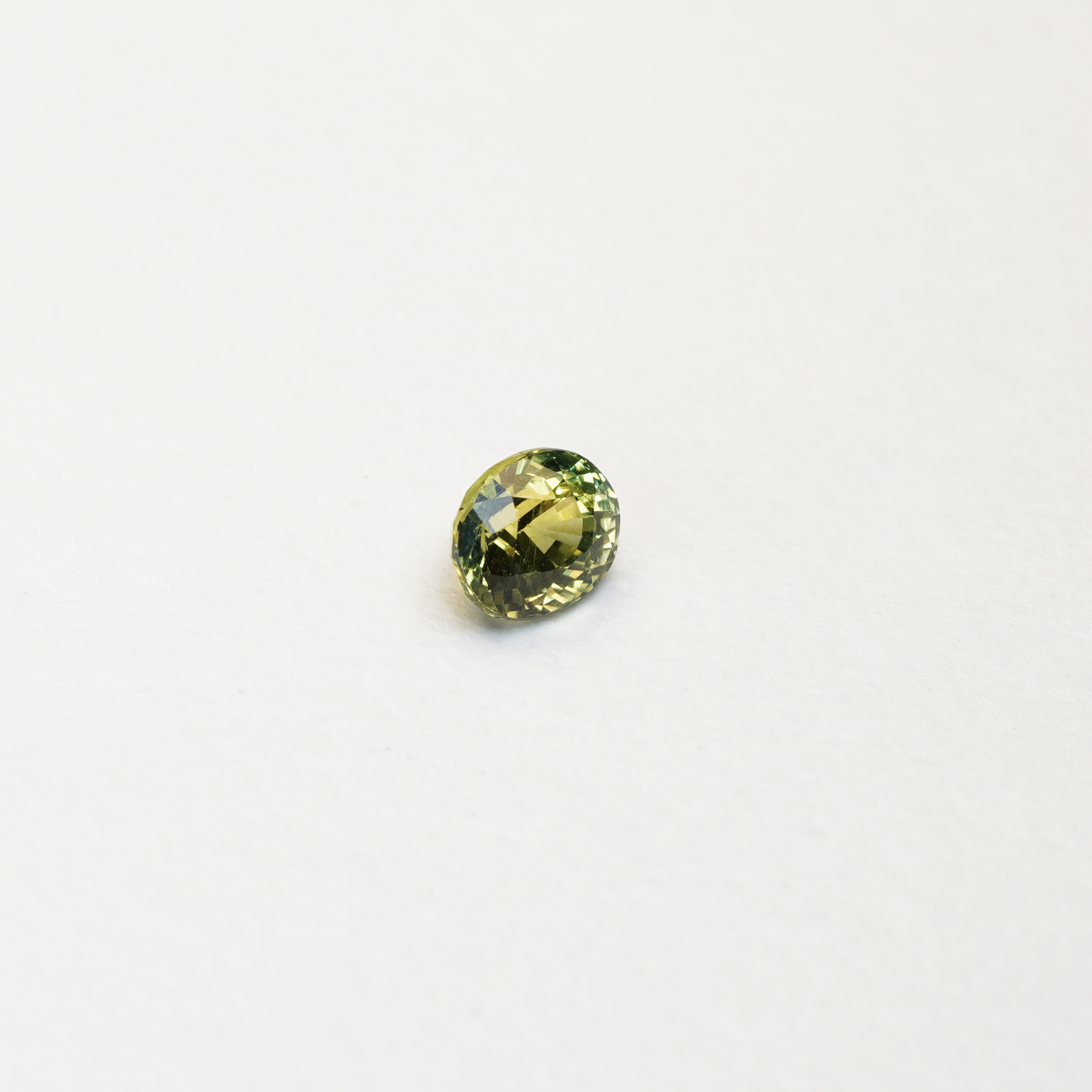 1 carat pear parti teal sapphire with mixed green and yellow color.
