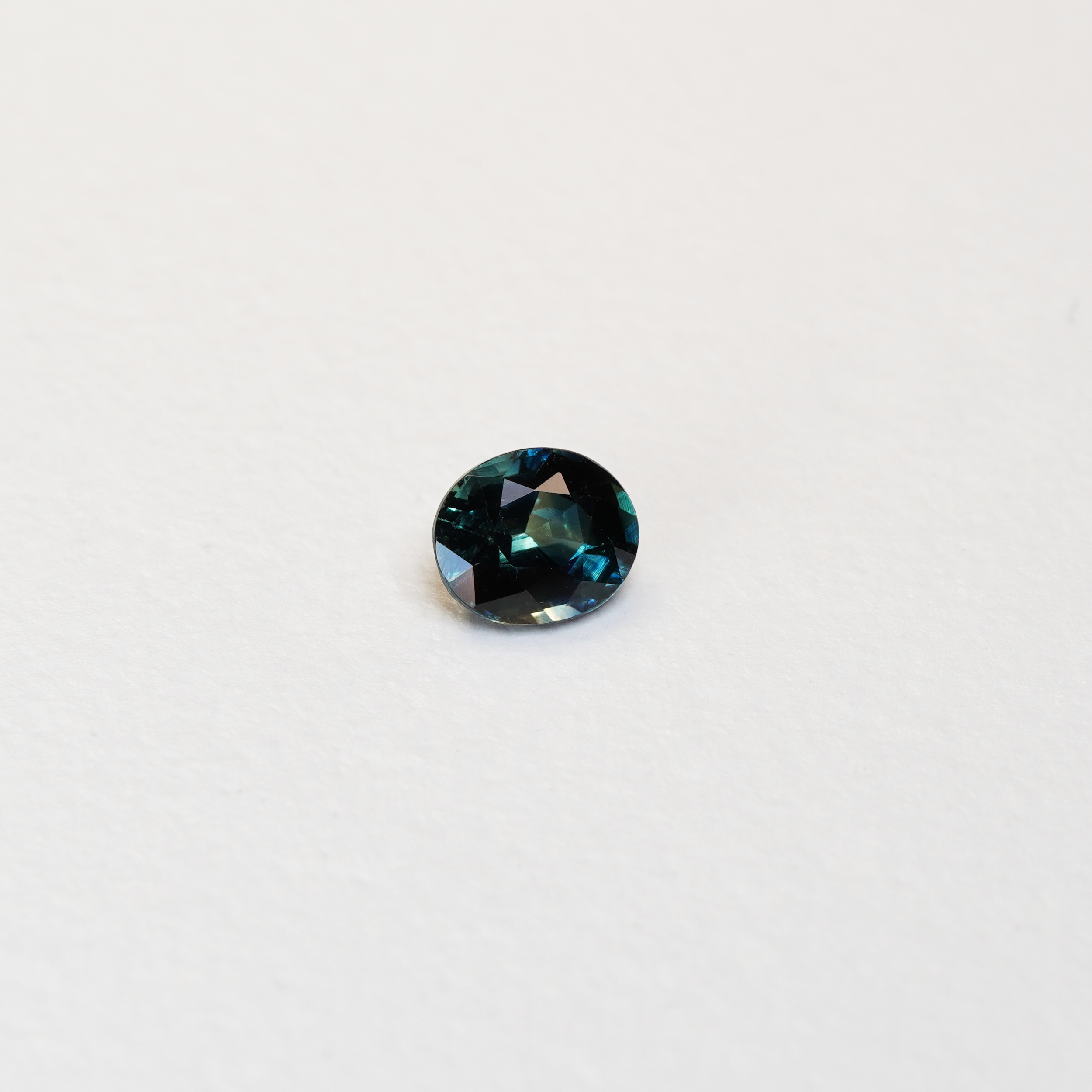 1.1 carat oval parti teal sapphire with mixed green and blue color.