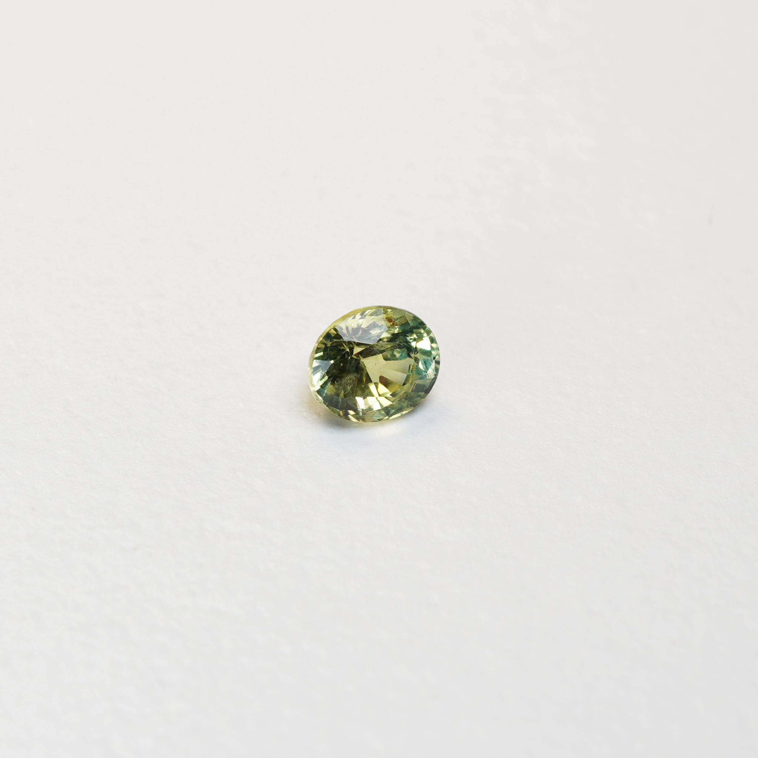 1 carat pear parti teal sapphire with mixed green and yellow color.
