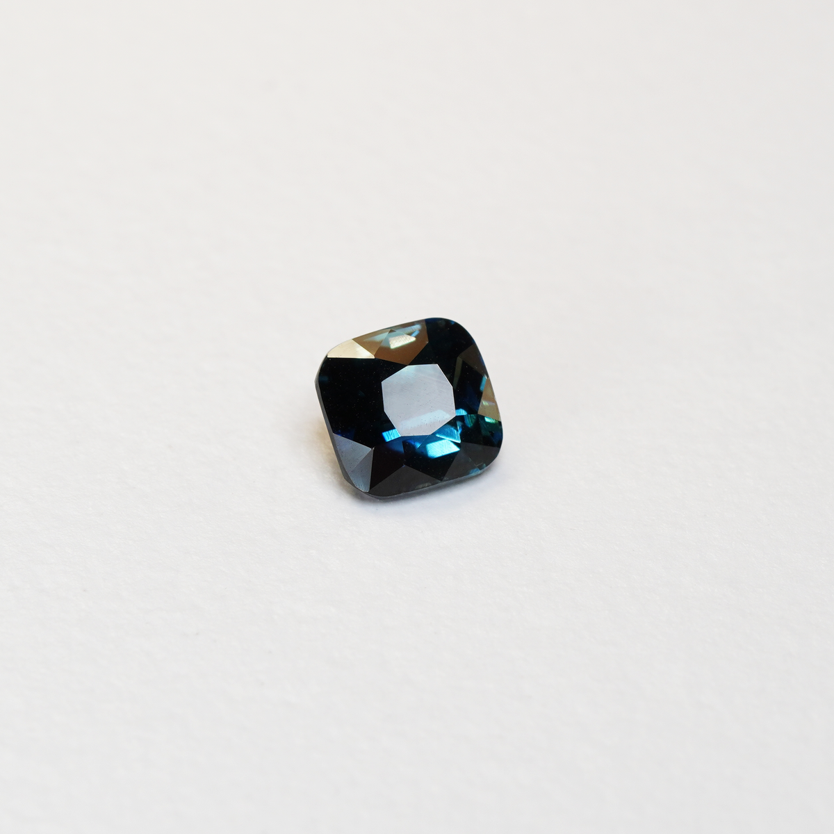 2.11 carat cushion cut teal parti sapphire with green and blue