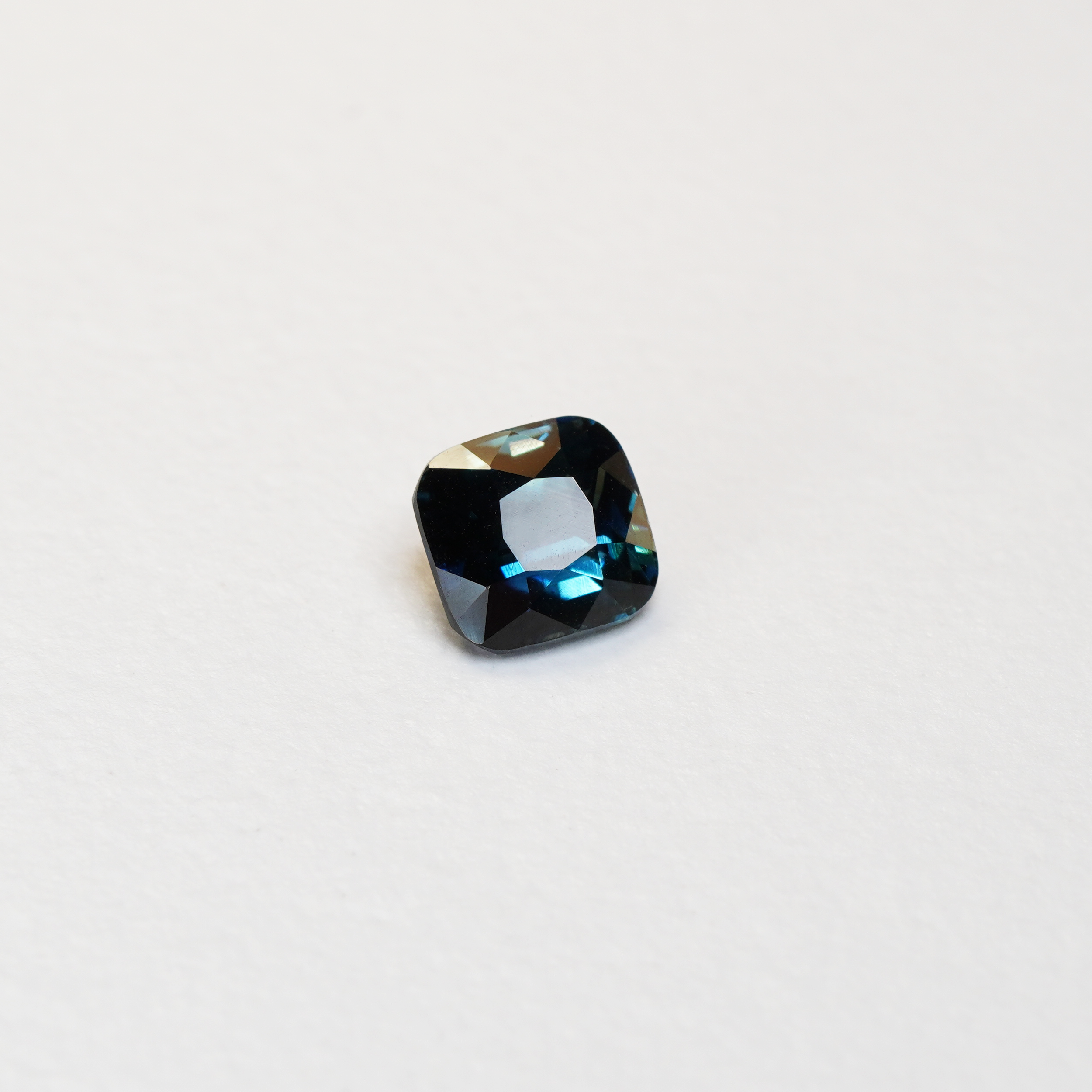 2.11 carat cushion cut teal parti sapphire with green and blue