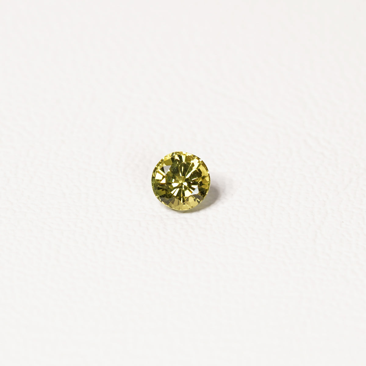 0.95ct Australian yellow-green sapphire round brilliant — vivid lime yellow-green, face-up view — Ruhuna Gemstones