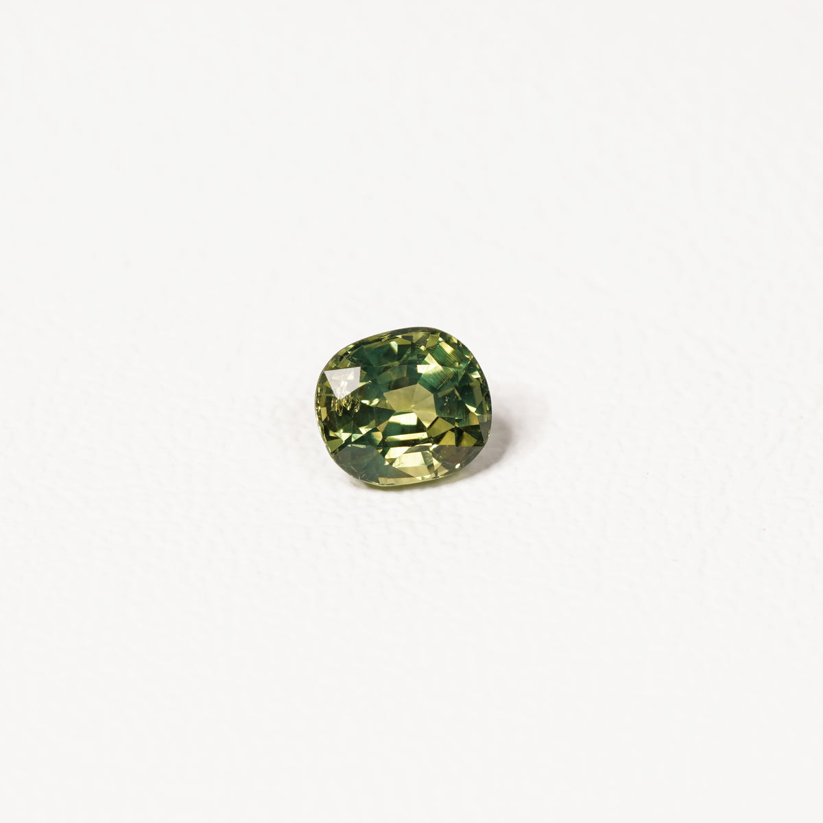 1.70ct Australian parti sapphire cushion — yellow-green centre with forest green crown, face-up — Ruhuna Gemstones