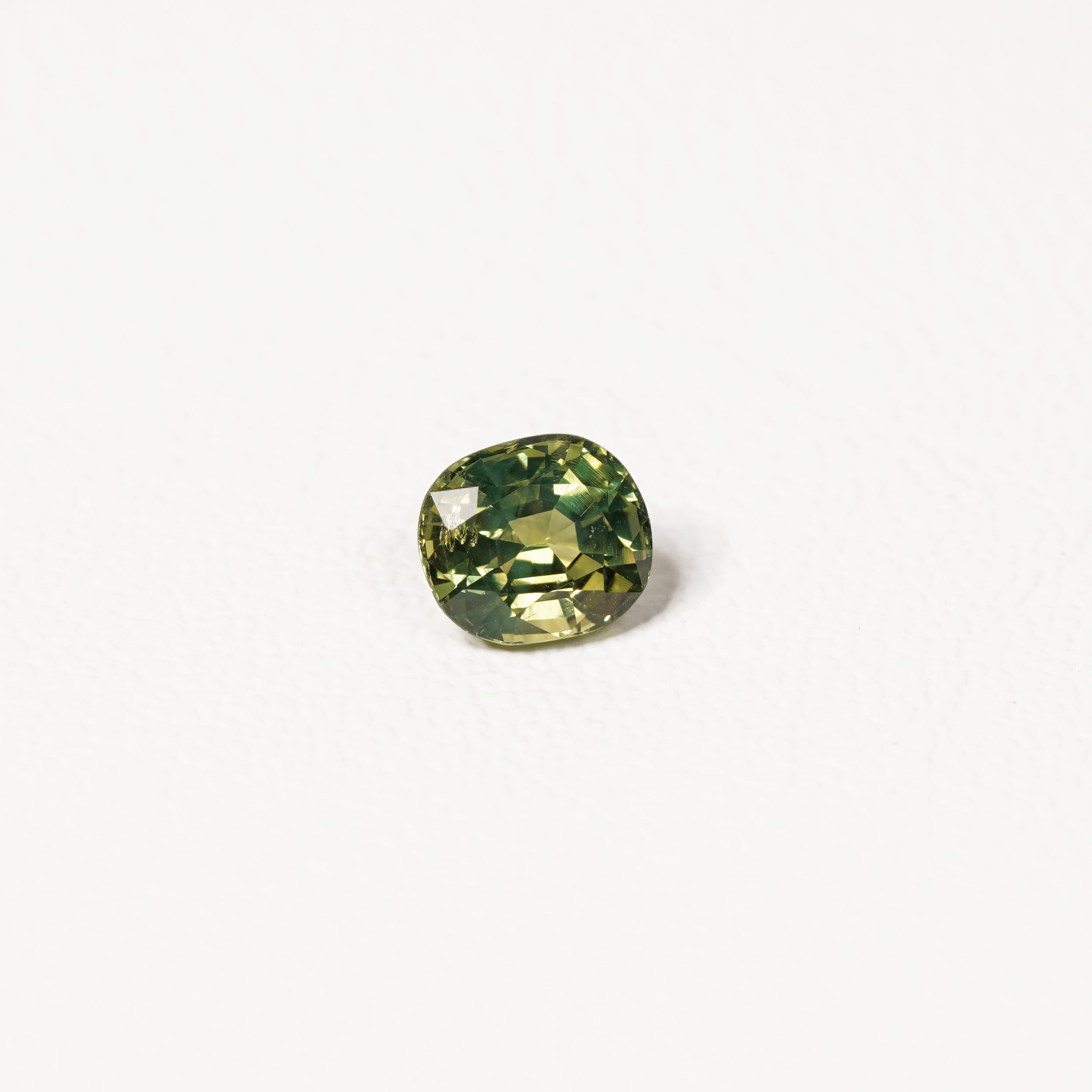 1.70ct Australian parti sapphire cushion — yellow-green centre with forest green crown, face-up — Ruhuna Gemstones