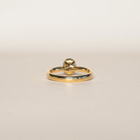 1.2 carat teal blue parti sapphire engagement ring with hidden halo in 18ct yellow gold. Cathedral settings 