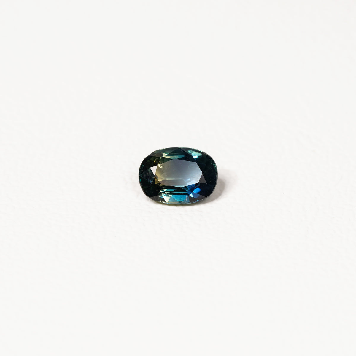  1.25ct Australian parti sapphire oval — deep teal with copper flash through table, face-up — Ruhuna Gemstones