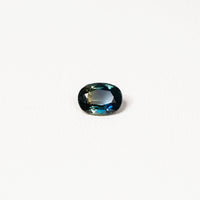  1.25ct Australian parti sapphire oval — deep teal with copper flash through table, face-up — Ruhuna Gemstones