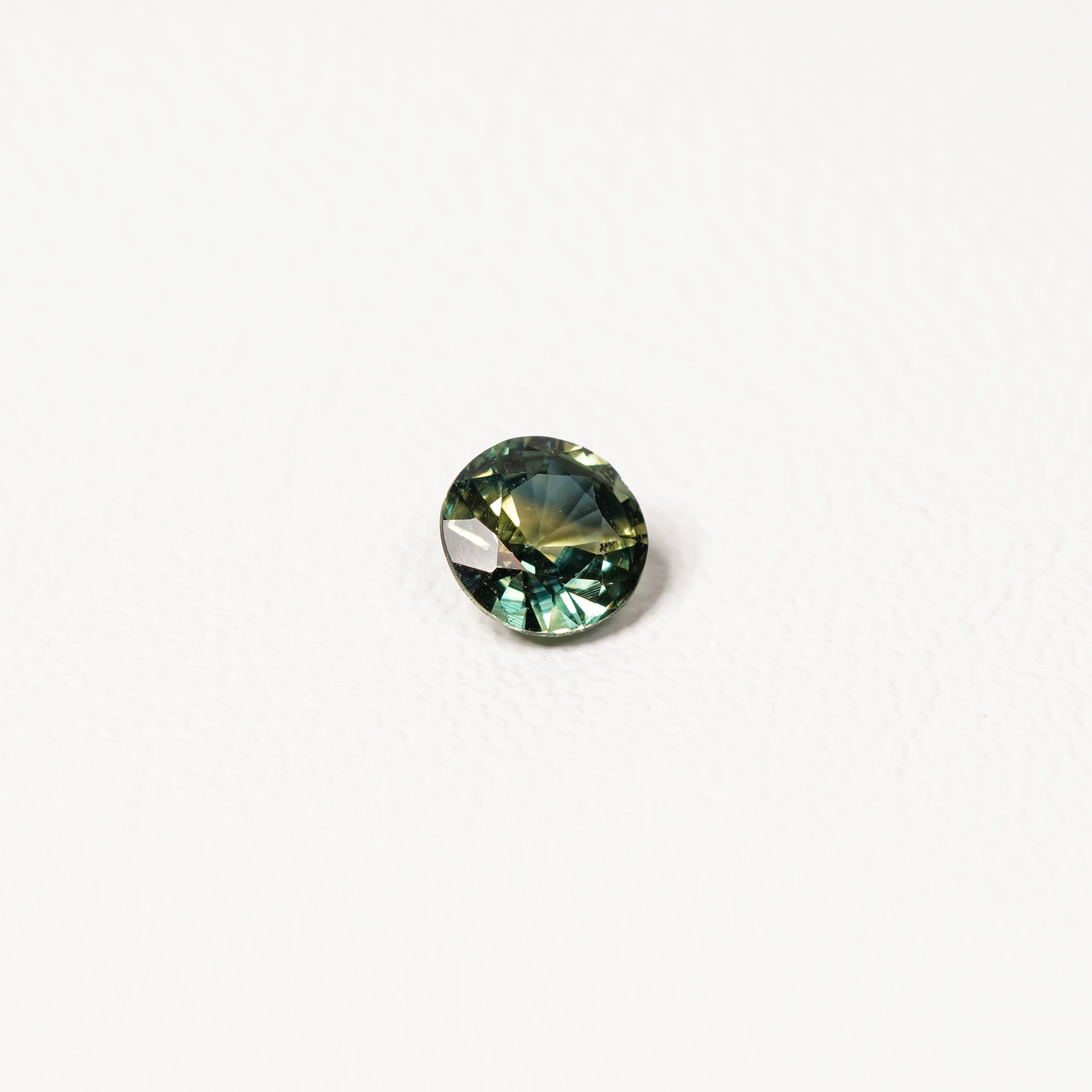 Australian parti sapphire 1.25ct — teal and yellow-green zoning visible at angle — Ruhuna Gemstones