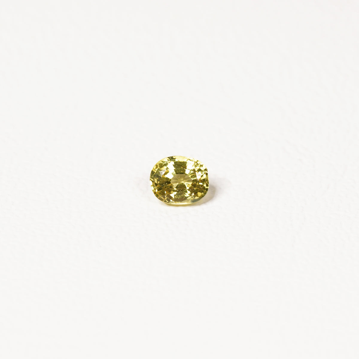 0.85ct Australian yellow-green sapphire cushion — soft pale chartreuse colour, face-up view — Ruhuna Gemstones