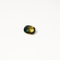 0.90ct Australian parti sapphire oval — golden yellow and teal-green colour zones, face-up — Ruhuna Gemstones