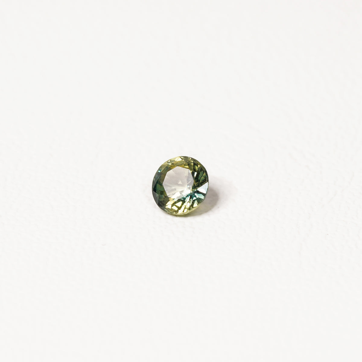 0.90ct Australian parti sapphire round — bright yellow-green body with teal crown accent, face-up — Ruhuna Gemstones