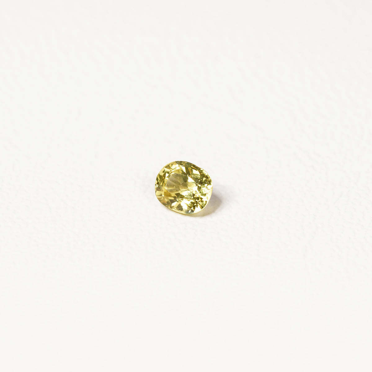 0.85ct Australian yellow-green sapphire cushion — soft pale chartreuse colour, face-up view — Ruhuna Gemstones