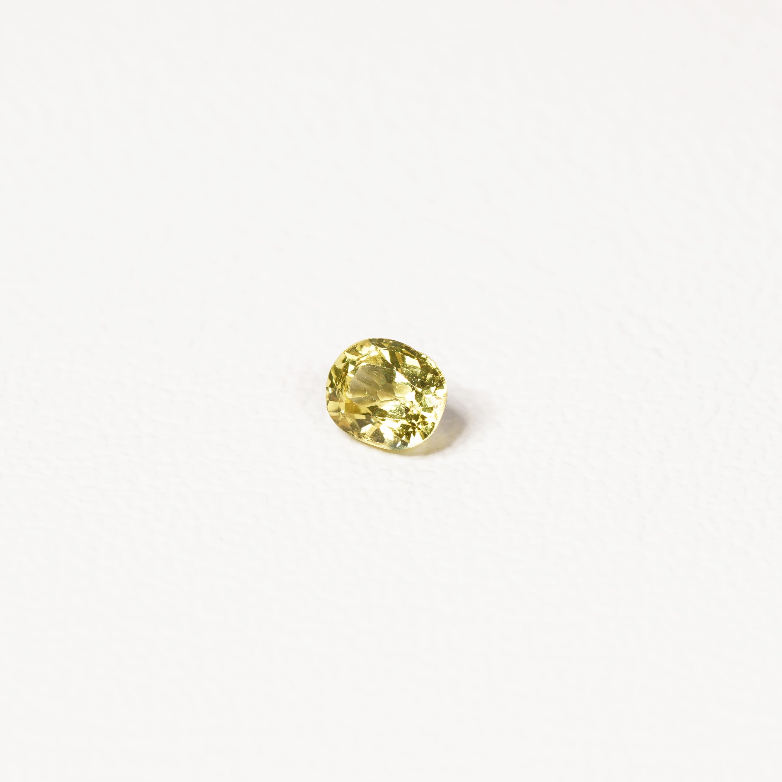 0.85ct Australian yellow-green sapphire cushion — soft pale chartreuse colour, face-up view — Ruhuna Gemstones