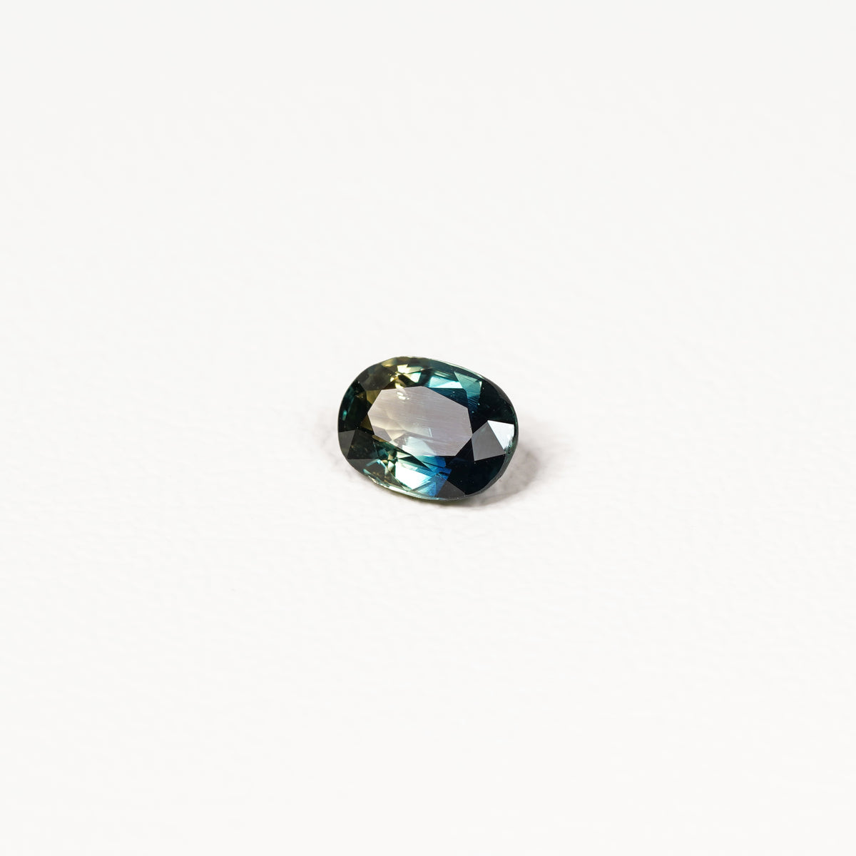  1.25ct Australian parti sapphire oval — deep teal with copper flash through table, face-up — Ruhuna Gemstones