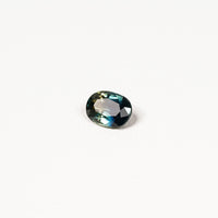  1.25ct Australian parti sapphire oval — deep teal with copper flash through table, face-up — Ruhuna Gemstones