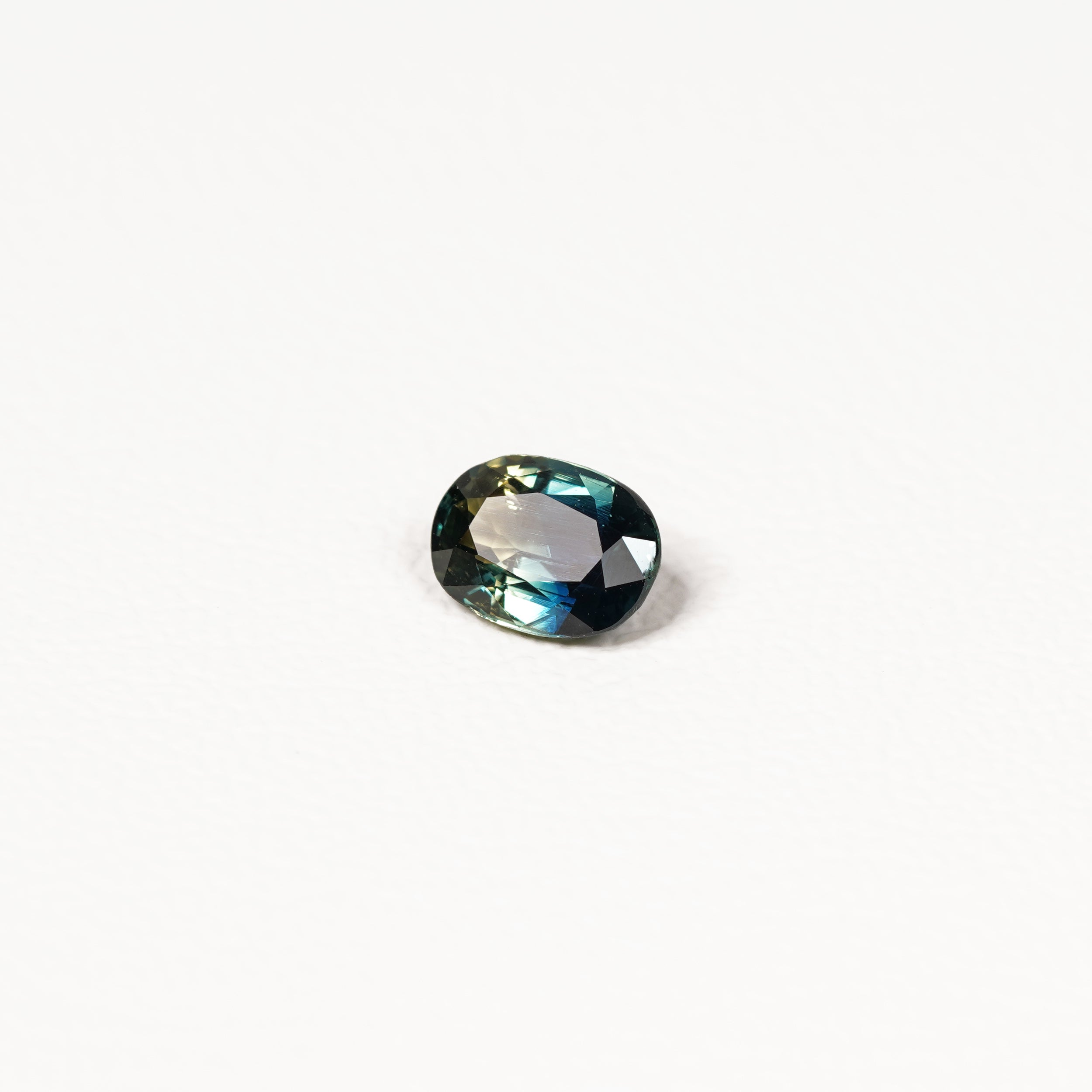  1.25ct Australian parti sapphire oval — deep teal with copper flash through table, face-up — Ruhuna Gemstones
