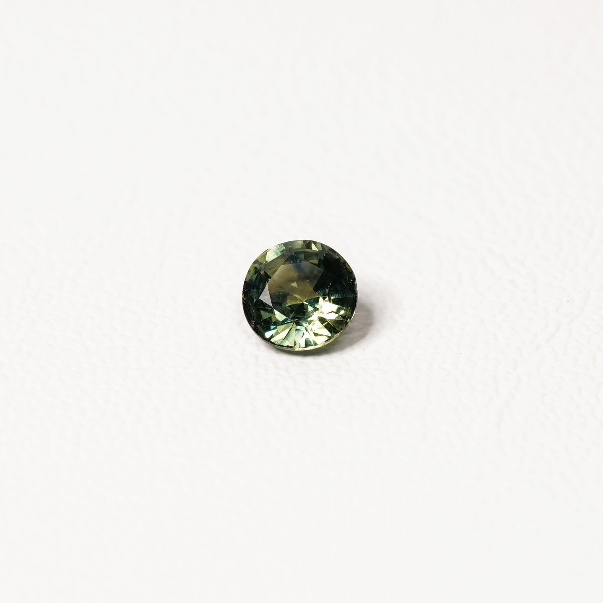Australian parti sapphire 1.25ct — teal and yellow-green zoning visible at angle — Ruhuna Gemstones